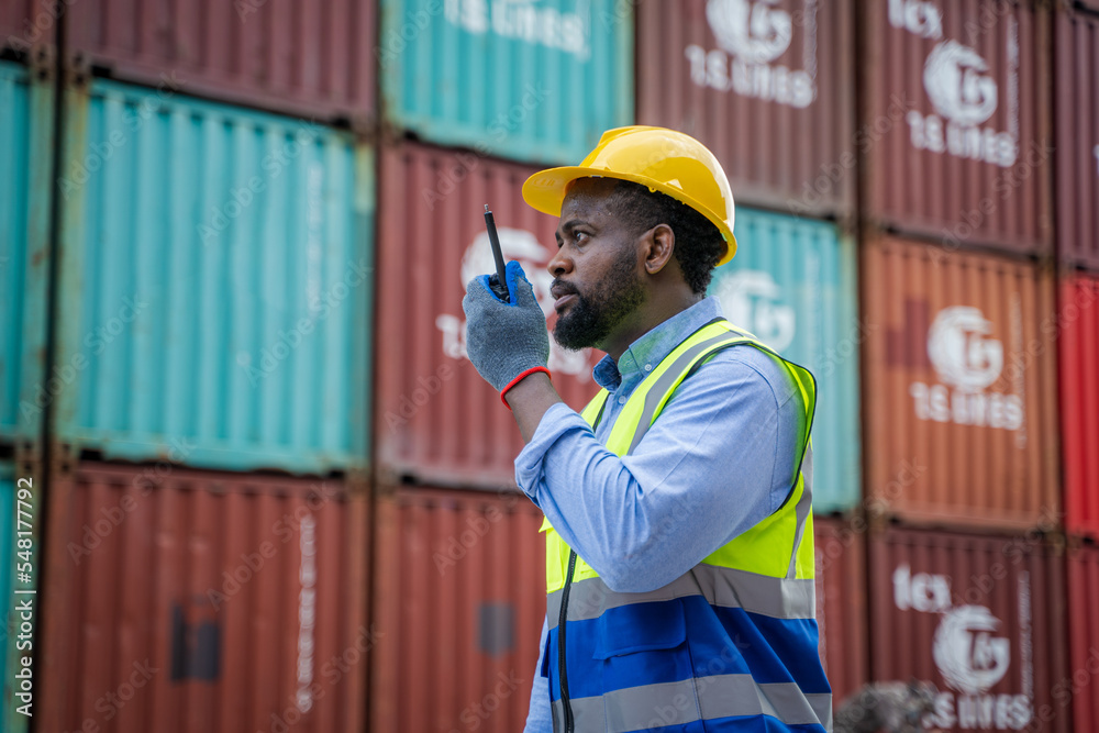 Poster Engineer using walkie talkie checking stock into container for loading,International shipping logistics.