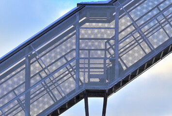 Fragment of an aboveground pedestrian crossing on a winter day