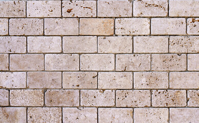 Stone decorative masonry wall background. Bricks made of natural stone surface backdrop. Design, decor, copy space