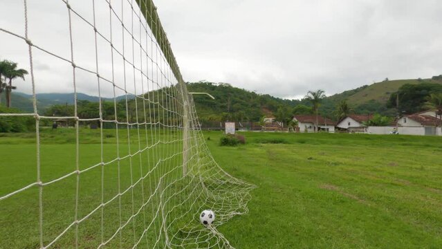 Soccer ball hitting the goal net. Scoring a goal in soccer