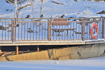 A fragment of a deserted park embankment on a winter day