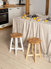 Two wooden round stools at the kitchen. Eco-style kitchen