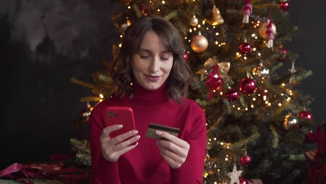 woman make purchase online using smartphone and credit card buy New Year gifts