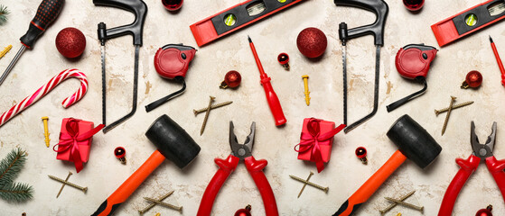 Worker's tools, Christmas decor and gifts on grunge background