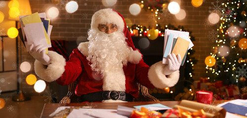 Santa Claus reading letters at home on Christmas eve