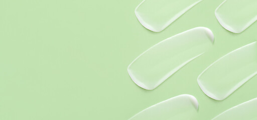 cosmetic smears cream texture on pastel green background view with place for text