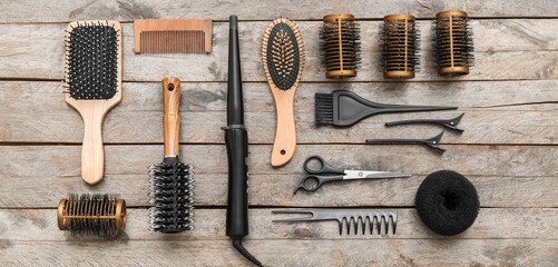 Set of hairdresser tools on wooden background, top view