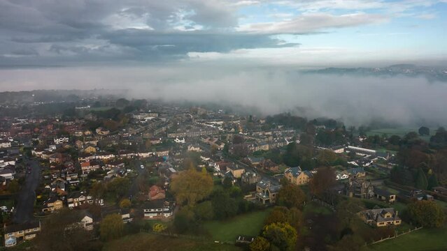 Aerial Drone Hyperlapse on Foggy Morning with Mist Moving Through Valley and Sunny Rays Over Fields in Calverley Village Leeds West Yorkshire UK