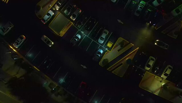 Austin Texas at night. Two vehicles pull in at the same time. The cinematic feel of the video is great for a short film.