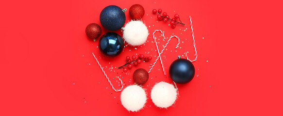 Beautiful Christmas decorations and candy canes on red background
