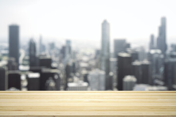 Empty tabletop made of wooden dies with blurry city view in sunny weather on background, template