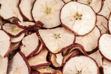 Dried pieces of apples winter cozy Christmas background. Cozy stylish winter and autumn food. Rustic dried fruits for winter hot mulled wine. 