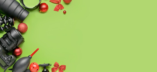 Modern devices of photographer and Christmas decor on green background with space for text