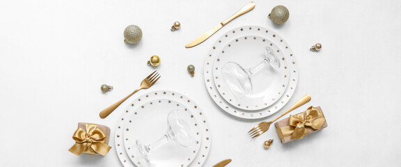 Beautiful table setting with golden Christmas decor on white background, top view