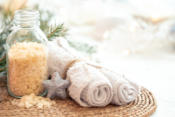 Winter spa composition with body care items and decor details.