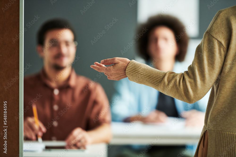 Aufkleber selective focus on hand of mature teacher or speaker making presentation of new subject in front of 