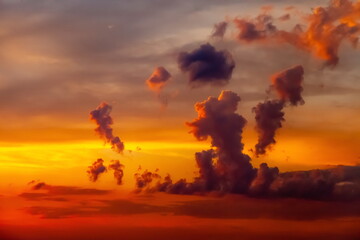 Fototapeta premium Clouds in the sky illuminated by the setting sun in summer