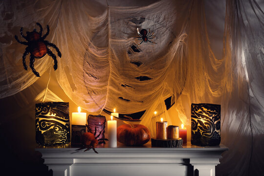 Different Halloween decor on fireplace indoors. Festive interior