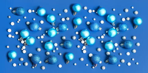 Many beautiful Christmas balls on blue background