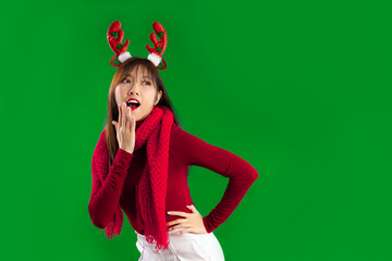 Young pretty asian woman in red and white Christmas theme costume wear reindeer horns headband...