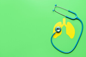 Yellow paper lungs with stethoscope on green background