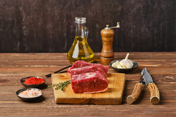 Raw beef brisket flat steak on wooden tabletop