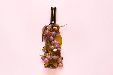 Composition with grape and broken bottle on light background