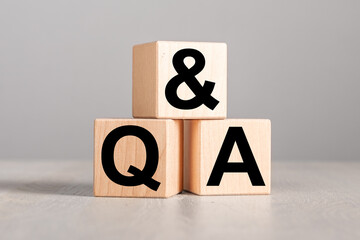Q and A, questions concept. QnA acronym on wood blocks on table