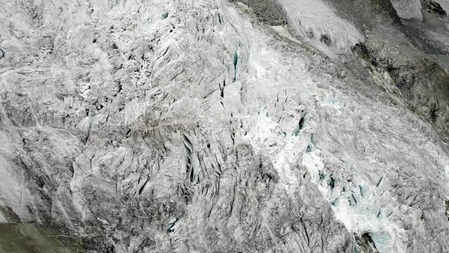 Aerial view over the Moiry glacier near Grimentz in Valais, Switzerland  panning towards the glacier and lake in the valley on a cloudy summer day