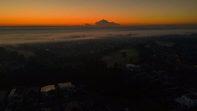 Aerial drone flying over town at dawn with Mist. stock videos 4K
