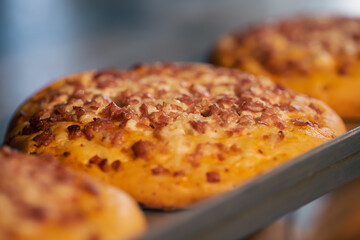 Freshly baked mini pizza on the counter in the bakery close-up.