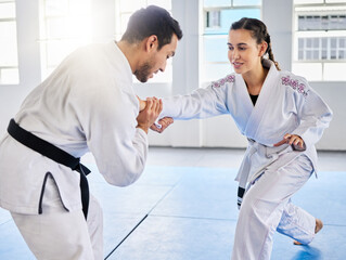 Man, karate and coach training woman in fitness, workout and exercise class for competition, black belt fight or self defense. Sports athlete, judo teacher and student in taekwondo power punch goals © Irshaad M/peopleimages.com