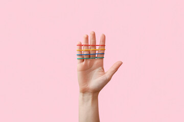 Woman with rubber bands on pink background