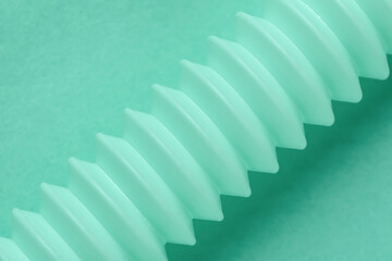 Closeup view of corrugated tubing on mint background