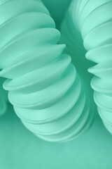 Closeup view of spiral corrugated tubing on mint background