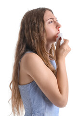 Young woman with nosebleed and tissue on white background