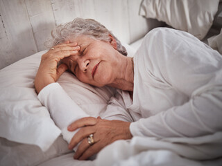 Elderly woman, sleeping and bed with headache to rest mind, tired body and dreaming for wellness in...