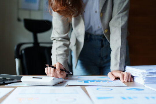 Accountants, Asian auditors are using calculators and computers to review annual tax budgets to submit information to the IRS.
