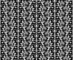 Wallpaper in the style of Baroque. Seamless vector background. White and black floral ornament. Graphic pattern for fabric, wallpaper, packaging. Ornate Damask flower ornament