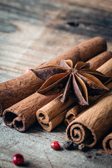 Obraz na płótnie Canvas Close-up, star anise and cinnamon sticks on a wooden background, macro shot.