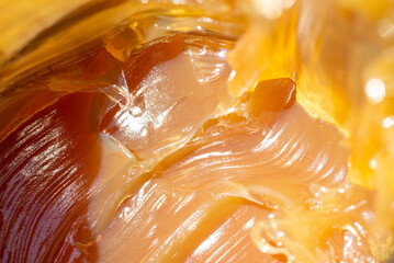Close up shot of anti-friction multi-purpose waterproof grease. Yellow orange machinery oil under...