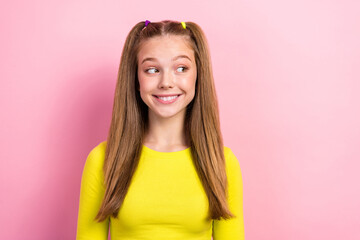 Portrait of interested good mood girl with straight hairdo wear yellow long sleeve look empty space isolated on yellow color background