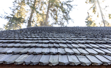 Close-up, the roof of a house made of wooden tiles.
