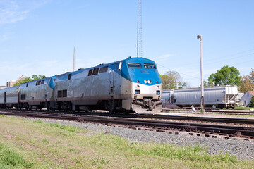 Fototapeta na wymiar Railroad Passenger Train Locomotives On Track Near Station