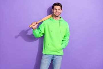 Photo of positive dangerous guy with brunet hairdo dressed green hoodie hold baseball bat on...