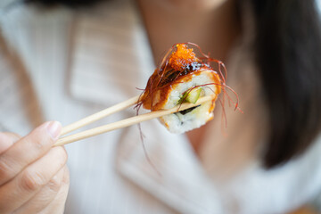 unagi sushi roll on chopstick