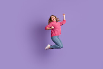 Full body size photo energetic active youth shout rejoice isolated raise hands arms win victory jump purple background