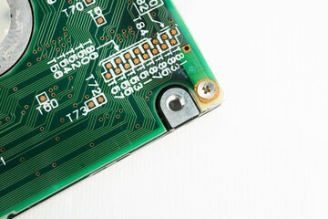 Closeup of a computer motherboard showing complicated circuits on white background