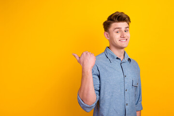 Young businessman wearing shirt smiling looking at camera pointing with two hands fingers side...