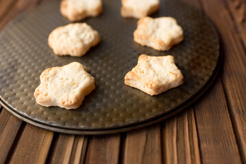 	
cookies in a plate on a wooden table